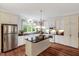 Bright kitchen with stainless steel appliances, granite countertops, and a functional center island at 452 Dogwood Trl, Henderson, NC 27537