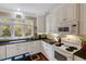 Well-lit kitchen features custom cabinets, granite countertops, and modern appliances for convenient cooking at 452 Dogwood Trl, Henderson, NC 27537