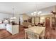 Open-concept kitchen and living area features island, hardwood floors, and ample natural light at 452 Dogwood Trl, Henderson, NC 27537