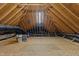 Unfinished attic space with exposed beams, a blank canvas for potential expansion or storage at 5016 Dillswood Ln, Raleigh, NC 27606