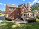 Spacious brick house with a patio, sunroom, and lush green lawn at 5016 Dillswood Ln, Raleigh, NC 27606