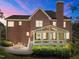 Brick home featuring a cozy sunroom, outdoor patio, and lush backyard perfect for relaxation and entertaining at 5016 Dillswood Ln, Raleigh, NC 27606