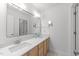 Bathroom featuring dual sinks and large framed mirror at 5016 Dillswood Ln, Raleigh, NC 27606