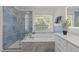 Elegant bathroom with blue tile, soaking tub, and glass-enclosed shower at 5016 Dillswood Ln, Raleigh, NC 27606