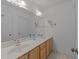 Bathroom featuring double sinks, and a large mirror, with neutral tones and ample lighting at 5016 Dillswood Ln, Raleigh, NC 27606