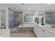 Bathroom features a soaking tub, walk-in shower with blue marbled tile, and double sink vanity at 5016 Dillswood Ln, Raleigh, NC 27606