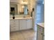 Bright bathroom featuring white vanity with drawers, a large mirror, and tile flooring at 5016 Dillswood Ln, Raleigh, NC 27606