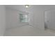 Bright bedroom with a window, neutral carpet, and white walls, offering a serene and minimalist appeal at 5016 Dillswood Ln, Raleigh, NC 27606