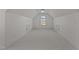 Empty bonus room showcasing a high ceiling, dormer window, and ample space at 5016 Dillswood Ln, Raleigh, NC 27606