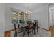Dining area featuring a modern table, area rug and abundant natural light from large windows at 5016 Dillswood Ln, Raleigh, NC 27606
