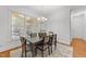 Eat-in dining area features a gray table and lots of windows overlooking the backyard at 5016 Dillswood Ln, Raleigh, NC 27606