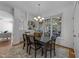 Formal dining area with a stylish light fixture and large window offering views of the sunroom at 5016 Dillswood Ln, Raleigh, NC 27606