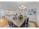 Bright dining room with large table, elegant chandelier, and easy access to the kitchen at 5016 Dillswood Ln, Raleigh, NC 27606