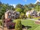 Brick two story home with manicured lawn, lush landscaping, and a welcoming entrance, showcasing curb appeal at 5016 Dillswood Ln, Raleigh, NC 27606