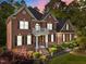 Stunning brick two-story home with black shutters and manicured landscaping at 5016 Dillswood Ln, Raleigh, NC 27606