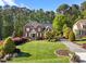 Beautiful brick home on a spacious lot, showcasing lush green lawns and mature trees at 5016 Dillswood Ln, Raleigh, NC 27606