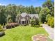 Stately brick home with a manicured lawn and mature trees creating a picturesque setting at 5016 Dillswood Ln, Raleigh, NC 27606