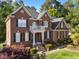 Beautiful two-story brick home with a front porch and well-manicured landscaping at 5016 Dillswood Ln, Raleigh, NC 27606