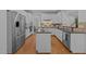 Spacious kitchen with granite counters, stainless appliances, island with sink, and hardwood floors at 5016 Dillswood Ln, Raleigh, NC 27606