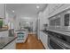 Bright kitchen featuring white cabinets, stainless steel appliances, hardwood floors and views of the dining area at 5016 Dillswood Ln, Raleigh, NC 27606