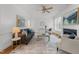Cozy living room with fireplace, ceiling fan, and large windows for plenty of natural light at 5016 Dillswood Ln, Raleigh, NC 27606