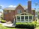 Brick home featuring a patio and sunroom offering great spaces to enjoy the outdoors at 5016 Dillswood Ln, Raleigh, NC 27606