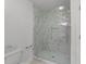Modern bathroom with a glass enclosed shower featuring marble-style tile and a rainfall showerhead at 5016 Dillswood Ln, Raleigh, NC 27606