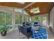 Bright sunroom featuring abundant windows, wood ceiling, and a cozy seating area with stylish decor at 5016 Dillswood Ln, Raleigh, NC 27606
