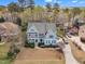 An aerial view showcasing a beautifully landscaped front yard with a two-story house at 5109 Dove Forest Ln, Apex, NC 27539