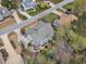 An aerial view of the backyard featuring patio, mature trees, and lush green lawn at 5109 Dove Forest Ln, Apex, NC 27539