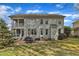 Two story back exterior view with patio, backyard, and dual-decked screened porch at 5109 Dove Forest Ln, Apex, NC 27539
