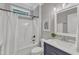 Modern bathroom features a shower-tub combo, stylish vanity, and neutral color palette at 5109 Dove Forest Ln, Apex, NC 27539