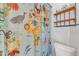 Bathroom featuring a colorful, fun shower curtain and ample shelving at 5109 Dove Forest Ln, Apex, NC 27539