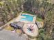 An aerial view of the community pool and clubhouse with playground equipment nearby at 5109 Dove Forest Ln, Apex, NC 27539
