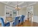 Open-concept dining area with hardwood floors and coffered ceilings, perfect for entertaining at 5109 Dove Forest Ln, Apex, NC 27539
