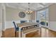 Formal dining room featuring hardwood floors, chandelier, wainscoting and coffered ceilings at 5109 Dove Forest Ln, Apex, NC 27539
