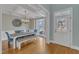 Bright dining room with coffered ceilings, wooden floors, and a window with neighborhood views at 5109 Dove Forest Ln, Apex, NC 27539