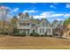 Stunning two-story house with a double porch, well-maintained lawn and beautiful blue skies at 5109 Dove Forest Ln, Apex, NC 27539