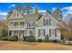 Charming two-story home featuring a double front porch and manicured landscaping at 5109 Dove Forest Ln, Apex, NC 27539