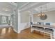 Hallway with wooden floors, and a view of the dining room and living area at 5109 Dove Forest Ln, Apex, NC 27539