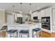 Gourmet kitchen features stainless appliances, kitchen island, and bar seating at 5109 Dove Forest Ln, Apex, NC 27539