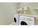 Laundry room features modern washer and dryer and storage shelves at 5109 Dove Forest Ln, Apex, NC 27539