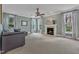 Inviting living room with a cozy fireplace, large windows, and comfortable seating at 5109 Dove Forest Ln, Apex, NC 27539