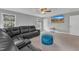Bright living room featuring a cozy sectional couch and a large-screen TV at 5109 Dove Forest Ln, Apex, NC 27539