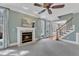 Comfortable living area with a fireplace, stairs, and an open floor plan at 5109 Dove Forest Ln, Apex, NC 27539
