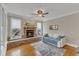 Bright living room with stone fireplace, hardwood floors, and large windows at 5109 Dove Forest Ln, Apex, NC 27539