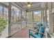 Cozy screened-in porch with wood floors, ceiling fan, and comfortable seating at 5109 Dove Forest Ln, Apex, NC 27539