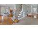 Carpeted staircase with wooden handrail and metal balusters connects the living spaces at 5109 Dove Forest Ln, Apex, NC 27539