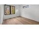 Cozy bedroom featuring hardwood floors, lots of light and large windows with black window frames at 512 Edgecreek Ct, Raleigh, NC 27604