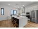 Modern kitchen featuring stainless steel appliances, a large island with seating, and pendant lighting at 512 Edgecreek Ct, Raleigh, NC 27604